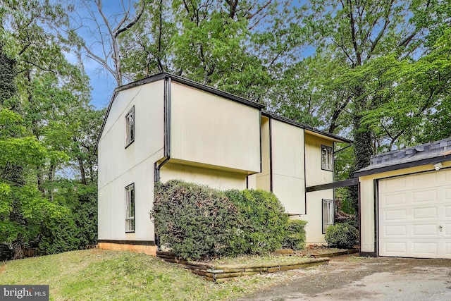 view of home's exterior with a garage and driveway