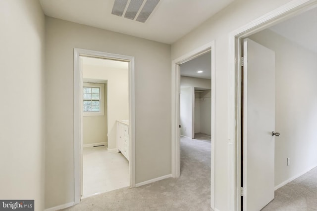 hall featuring light carpet and baseboards