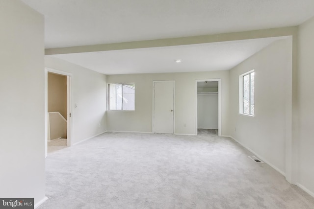 unfurnished bedroom with light carpet and baseboards