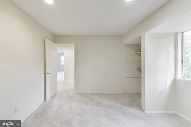 carpeted spare room featuring baseboards