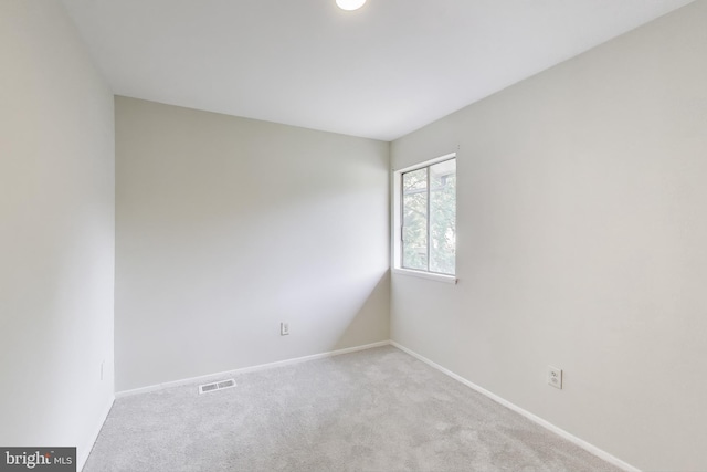 carpeted empty room with baseboards