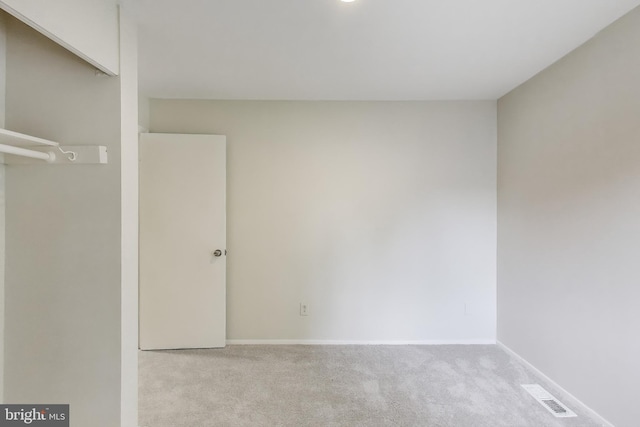 unfurnished bedroom featuring carpet flooring and baseboards