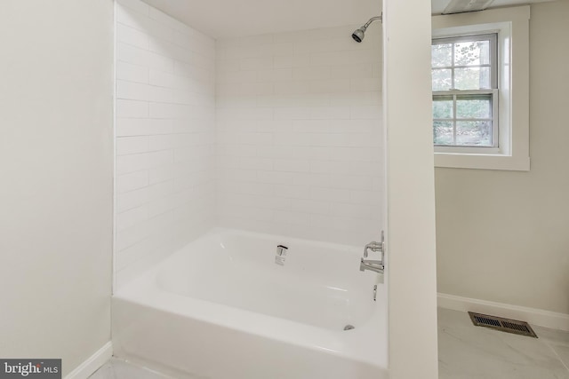 bathroom featuring baseboards and shower / washtub combination