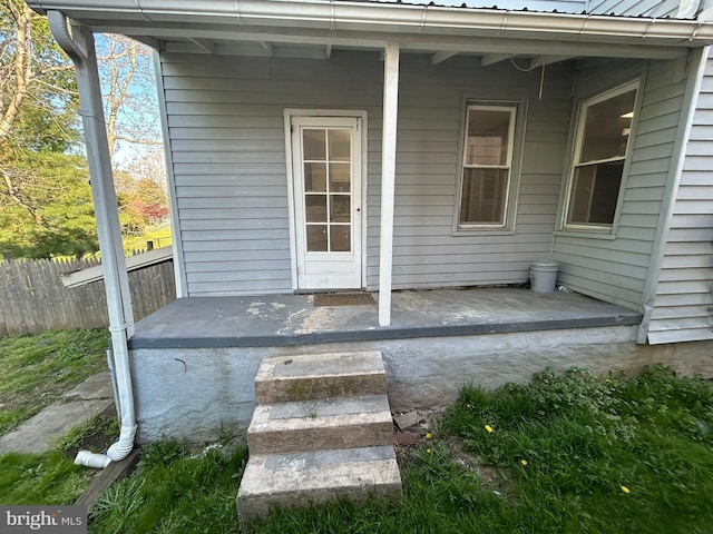 view of exterior entry with fence