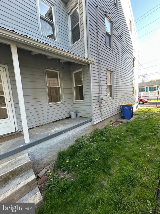 view of property exterior with a lawn