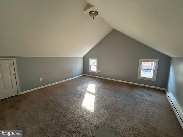bonus room featuring a baseboard heating unit, healthy amount of natural light, lofted ceiling, carpet flooring, and baseboards