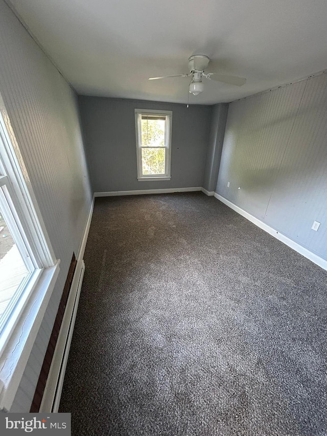 empty room with a ceiling fan and baseboards
