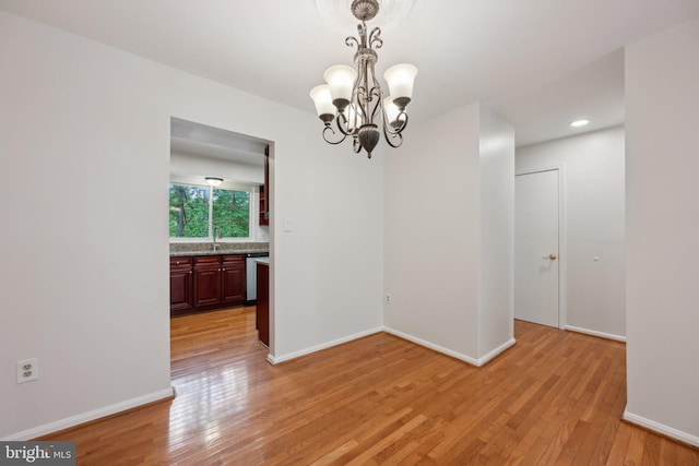 2327 London Bridge Dr, Silver Spring, MD 20906 - spare room with a chandelier, light wood-type flooring, a sink, baseboards, and recessed lighting
