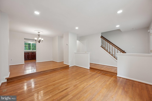 2327 London Bridge Dr, Silver Spring, MD 20906 - unfurnished living room with a chandelier, stairway, light wood finished floors, recessed lighting, and baseboards