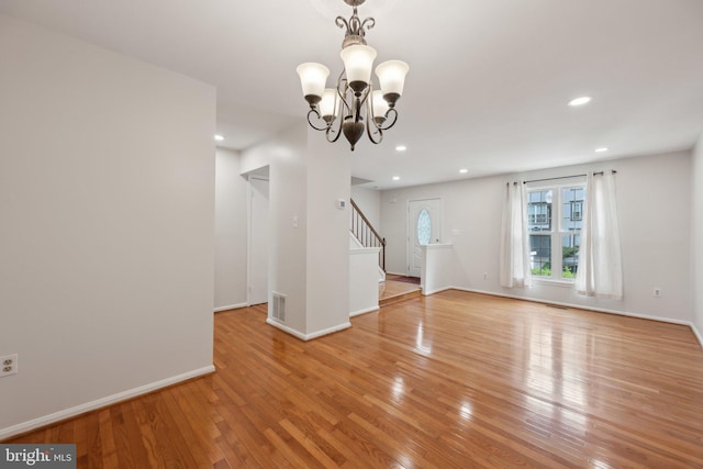 2327 London Bridge Dr, Silver Spring, MD 20906 - unfurnished living room with light wood-type flooring, a chandelier, stairs, recessed lighting, and baseboards