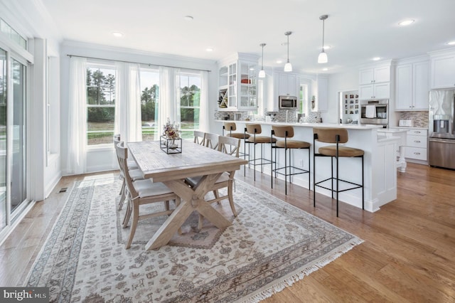 23336 Horse Island Rd, Lewes, DE 19958 - dining space with recessed lighting, visible vents, light wood-style flooring, and crown molding