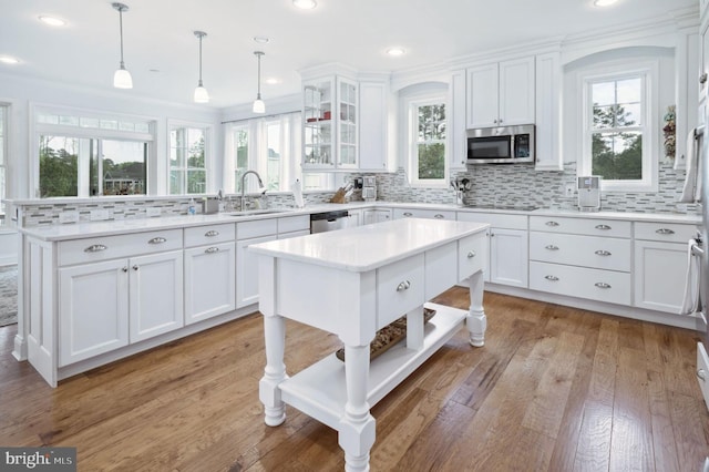 23336 Horse Island Rd, Lewes, DE 19958 - kitchen featuring a peninsula, a sink, white cabinets, appliances with stainless steel finishes, and decorative backsplash
