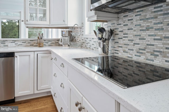 23336 Horse Island Rd, Lewes, DE 19958 - kitchen with white cabinets, dishwasher, decorative backsplash, and black electric stovetop