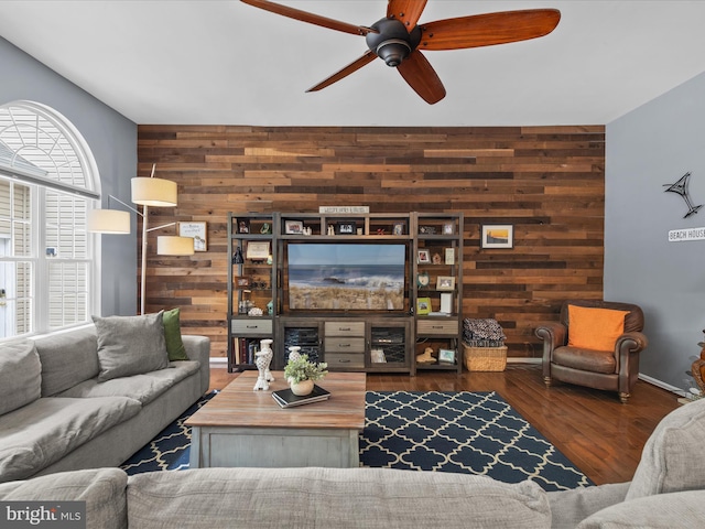33759 Bay Ridge Ln, Lewes, DE 19958 - living room featuring wooden walls, ceiling fan, wood finished floors, and an accent wall