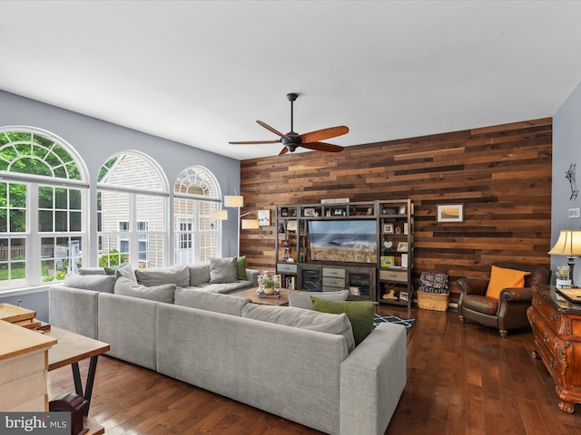 33759 Bay Ridge Ln, Lewes, DE 19958 - living area with wooden walls, healthy amount of natural light, ceiling fan, an accent wall, and wood finished floors