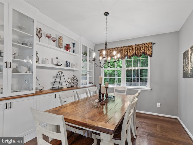 33759 Bay Ridge Ln, Lewes, DE 19958 - dining room with dark wood finished floors, a chandelier, and baseboards