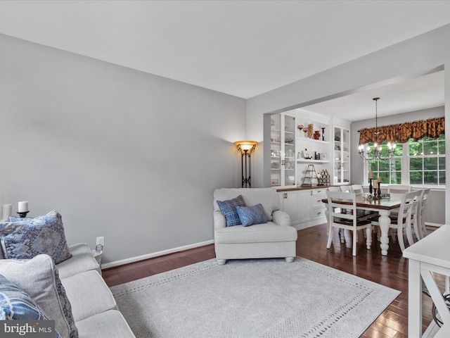 33759 Bay Ridge Ln, Lewes, DE 19958 - living area featuring wood finished floors, a chandelier, and baseboards