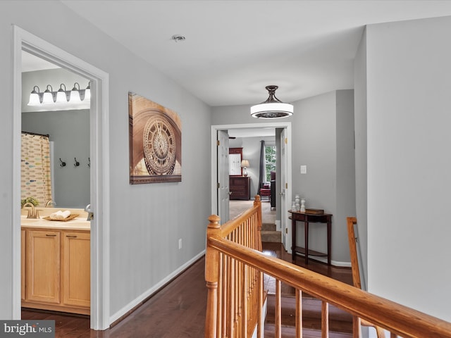 33759 Bay Ridge Ln, Lewes, DE 19958 - hall with dark wood-style floors, an upstairs landing, and baseboards