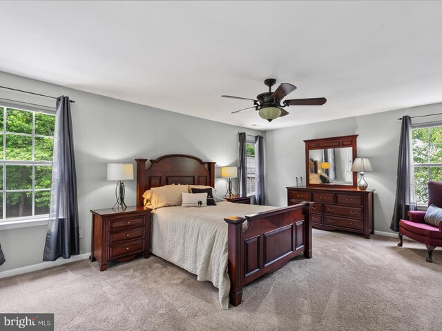 33759 Bay Ridge Ln, Lewes, DE 19958 - bedroom with light colored carpet, baseboards, and a ceiling fan