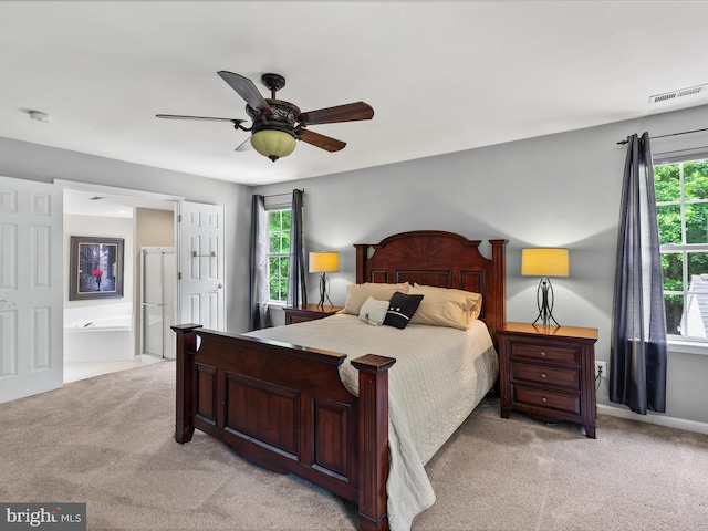 33759 Bay Ridge Ln, Lewes, DE 19958 - bedroom with light colored carpet, multiple windows, a ceiling fan, and connected bathroom