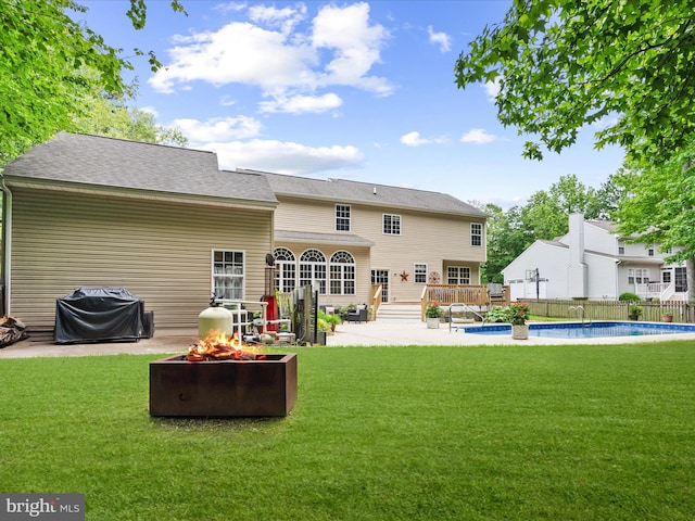 33759 Bay Ridge Ln, Lewes, DE 19958 - back of property featuring an outdoor fire pit, a patio area, and a deck