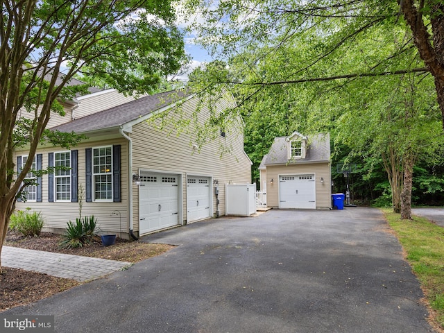 33759 Bay Ridge Ln, Lewes, DE 19958 - view of side of property with a garage, driveway, and a shingled roof