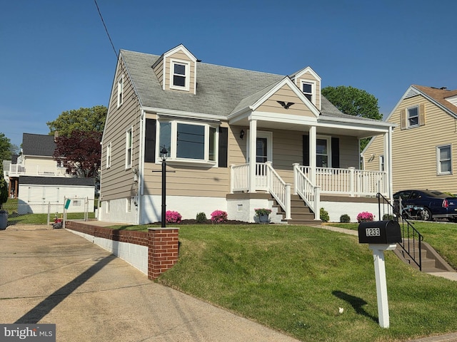 1233 Kendrick Rd, Rosedale, MD 21237 - view of front facade featuring a porch, a front yard, and a shingled roof