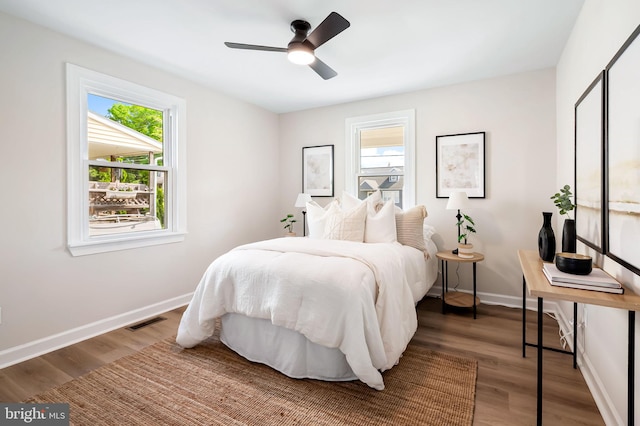 1233 Kendrick Rd, Rosedale, MD 21237 - bedroom with multiple windows, wood finished floors, and baseboards