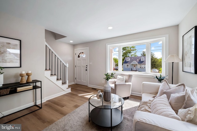 1233 Kendrick Rd, Rosedale, MD 21237 - living room featuring wood finished floors, stairway, recessed lighting, and baseboards