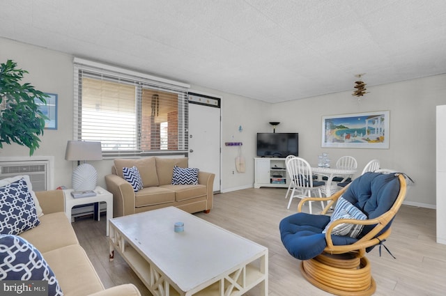 6 141st St Unit 304, Ocean City, MD 21842 - living area with wood finished floors, an AC wall unit, and baseboards