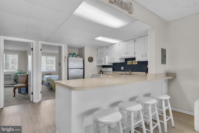 6 141st St Unit 304, Ocean City, MD 21842 - kitchen with white appliances, a sink, light wood finished floors, light countertops, and a paneled ceiling