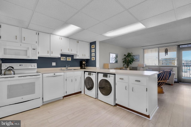 6 141st St Unit 304, Ocean City, MD 21842 - laundry area with healthy amount of natural light, light wood-style floors, and washer and clothes dryer