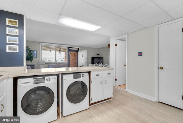6 141st St Unit 304, Ocean City, MD 21842 - laundry room with washer and dryer, light wood-style flooring, and baseboards