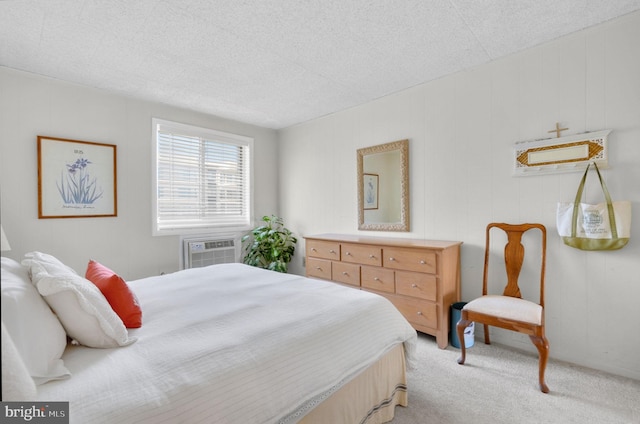 6 141st St Unit 304, Ocean City, MD 21842 - bedroom featuring light colored carpet, a wall mounted air conditioner, and a textured ceiling