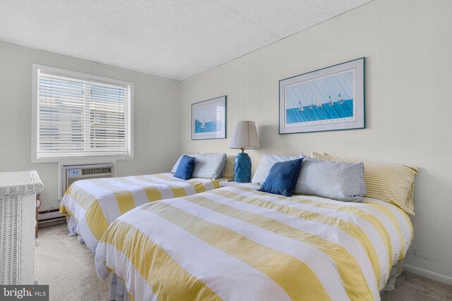 6 141st St Unit 304, Ocean City, MD 21842 - bedroom featuring light carpet, a baseboard heating unit, a wall mounted AC, and a textured ceiling