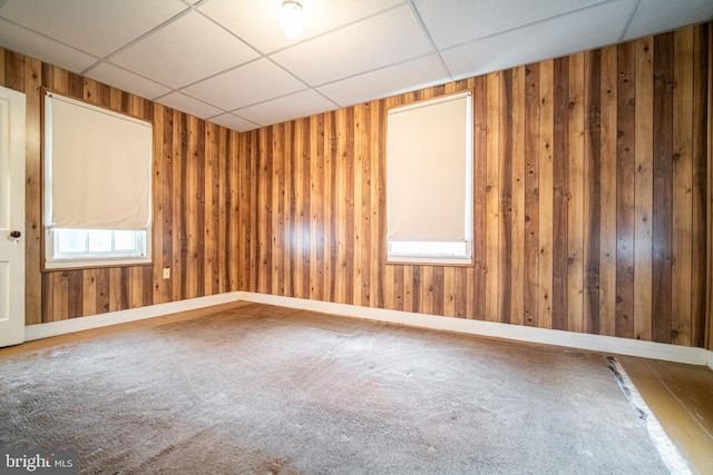 614 W Front St, Marietta, PA 17547 - carpeted empty room featuring a drop ceiling, wooden walls, and baseboards