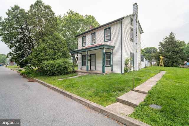 614 W Front St, Marietta, PA 17547 - view of front facade with a chimney, covered porch, and a front lawn