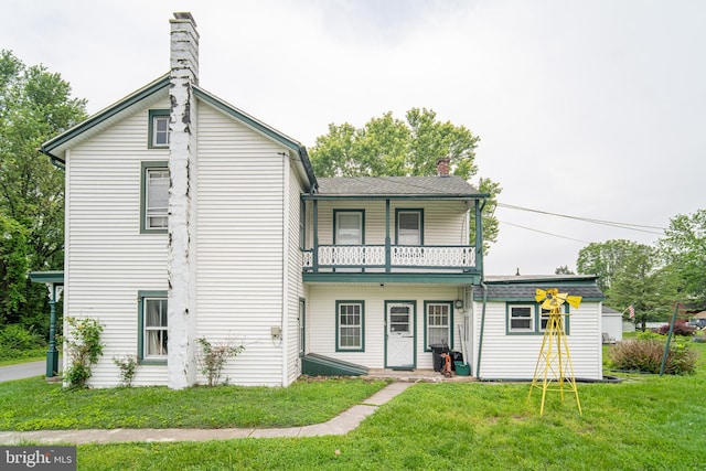 614 W Front St, Marietta, PA 17547 - rear view of house with a balcony, a chimney, and a yard