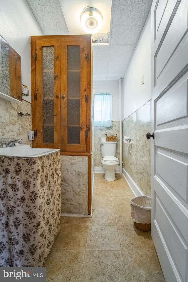 614 W Front St, Marietta, PA 17547 - bathroom with toilet, vanity, and wainscoting