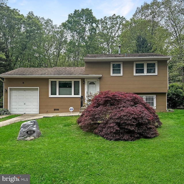split level home with a front lawn, driveway, and a garage