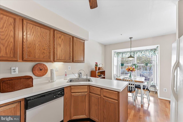 416 Hartford Sq Unit 41, West Chester, PA 19380 - kitchen with white appliances, a sink, a peninsula, light wood finished floors, and light countertops