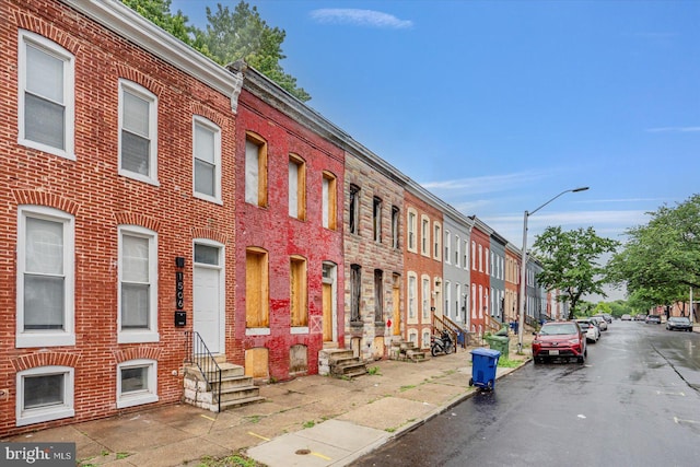 view of property featuring entry steps and a residential view