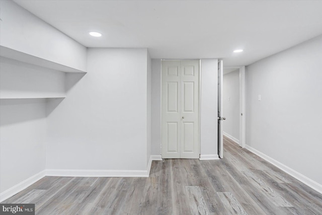 finished basement with wood finished floors, baseboards, and recessed lighting
