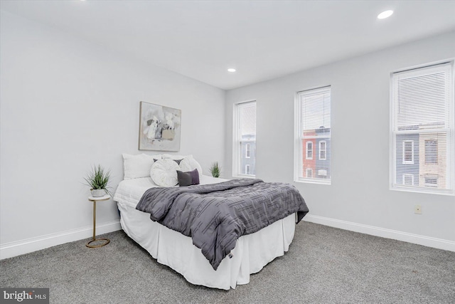 carpeted bedroom featuring baseboards and recessed lighting