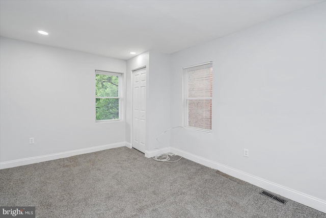 carpeted empty room with baseboards and recessed lighting