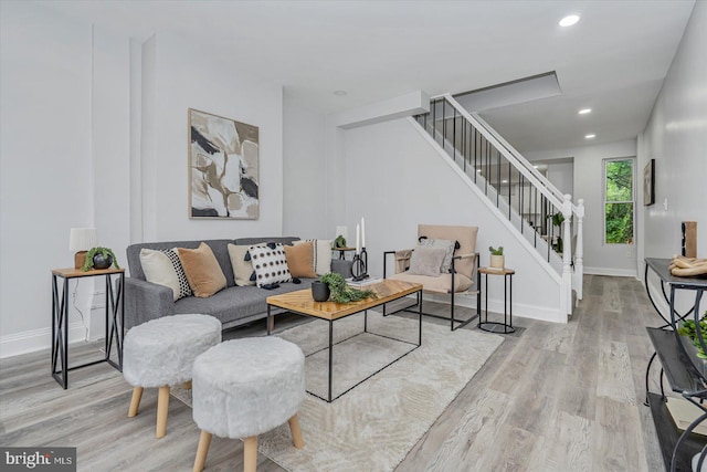 living area featuring stairway, wood finished floors, baseboards, and recessed lighting