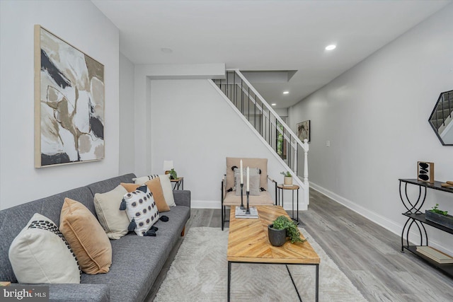 living area with stairway, wood finished floors, recessed lighting, and baseboards