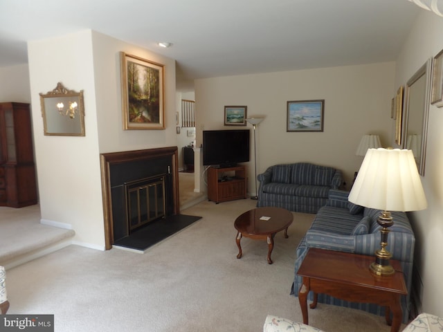 living room with light colored carpet and a glass covered fireplace