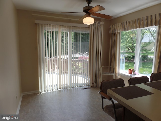living area featuring ceiling fan and baseboards