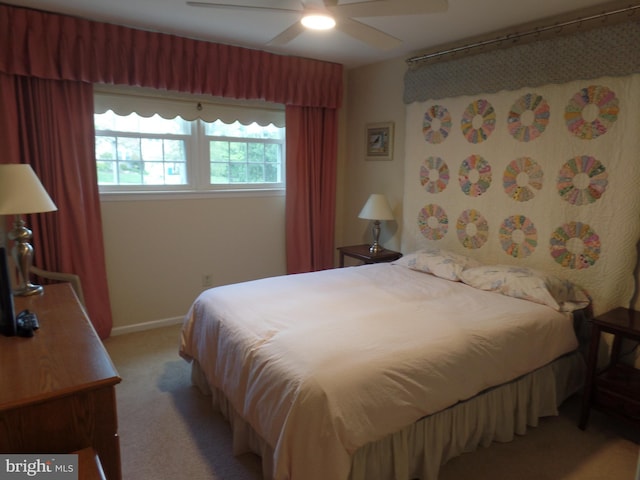 bedroom with light carpet, ceiling fan, and baseboards